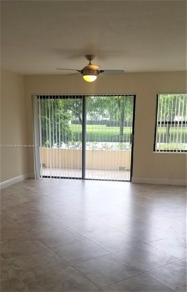 spare room featuring plenty of natural light and ceiling fan