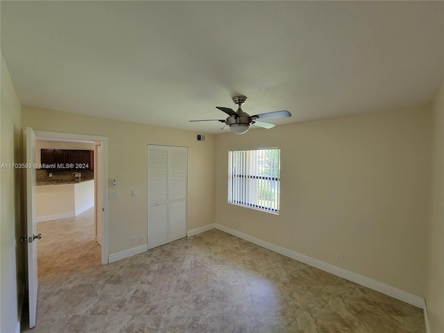 unfurnished bedroom with a closet and ceiling fan