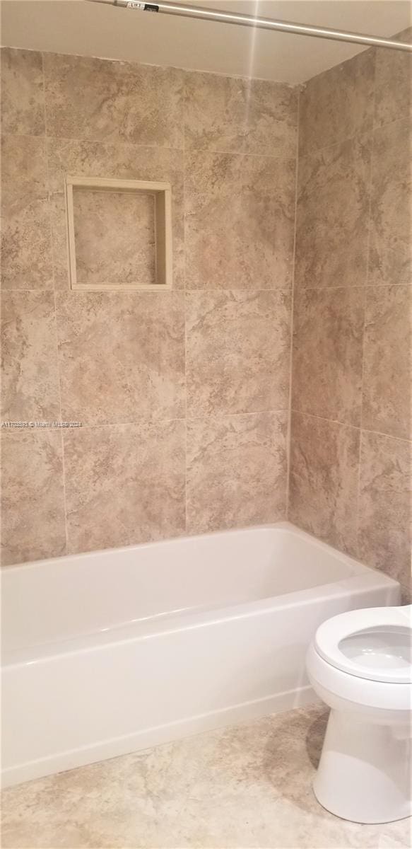 bathroom featuring toilet and shower / bathtub combination