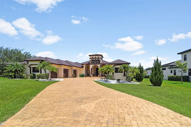 mediterranean / spanish-style home with a garage and a front yard