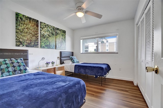 bedroom with ceiling fan, a closet, and dark wood-type flooring