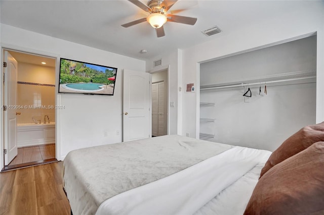 bedroom with connected bathroom, ceiling fan, a closet, and wood-type flooring