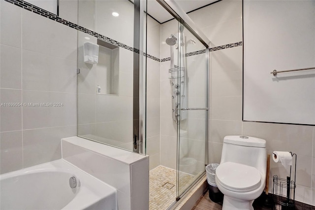 bathroom with plus walk in shower, tile walls, and toilet