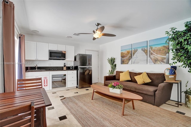 living room featuring ceiling fan and sink