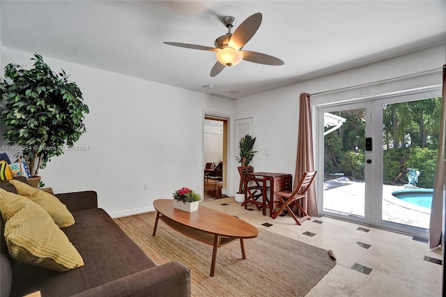 living room featuring ceiling fan and french doors