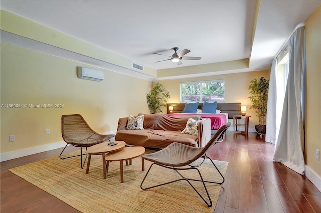 living room with ceiling fan, dark wood-type flooring, and a wall mounted AC