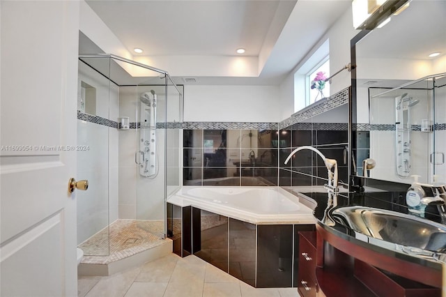 bathroom featuring tile patterned flooring, vanity, and separate shower and tub