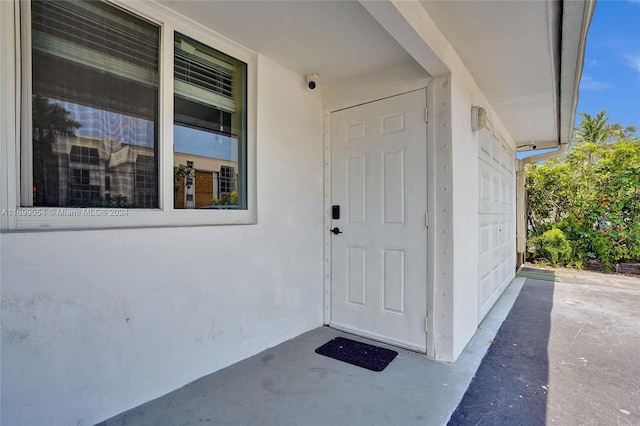 doorway to property with a garage