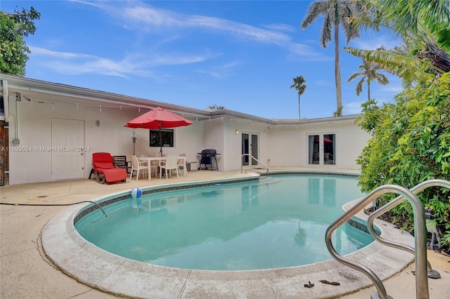 rear view of property featuring a patio and french doors