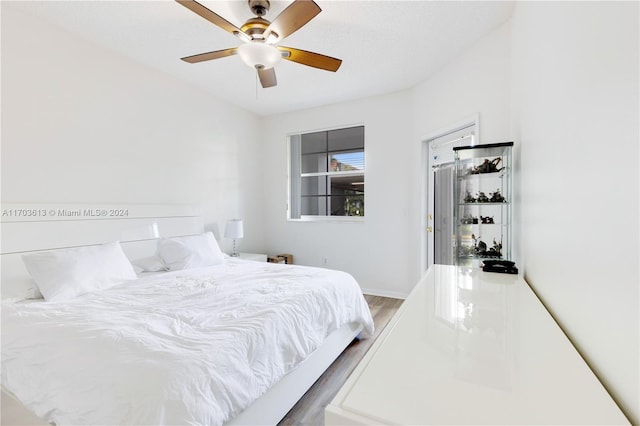 bedroom featuring ceiling fan and hardwood / wood-style floors