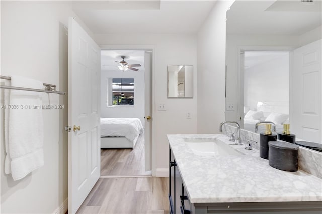 bathroom with wood-type flooring, vanity, and ceiling fan