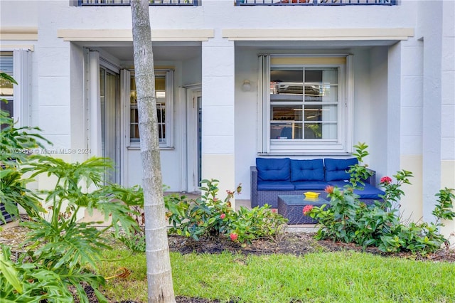 view of exterior entry featuring an outdoor living space