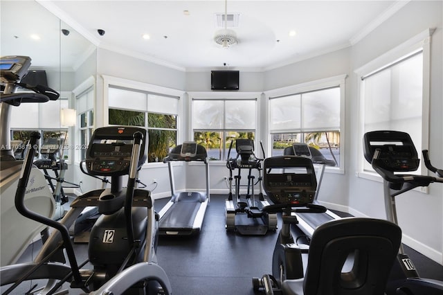 exercise room featuring ceiling fan and ornamental molding