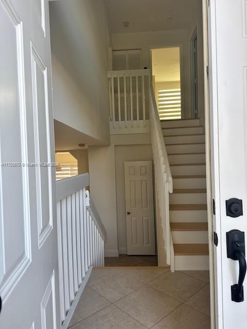 stairs featuring tile patterned floors