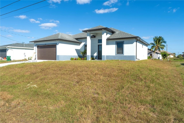 view of front of house featuring a front lawn and a garage