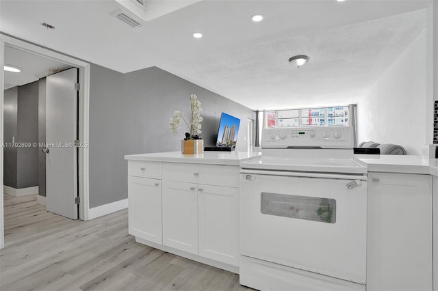 kitchen with white electric range, light hardwood / wood-style flooring, a textured ceiling, and white cabinets