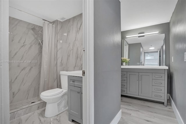 bathroom with vanity, curtained shower, and toilet