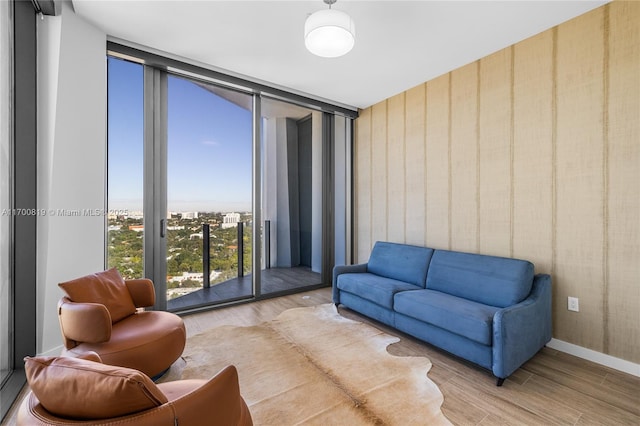 living room with hardwood / wood-style floors and expansive windows