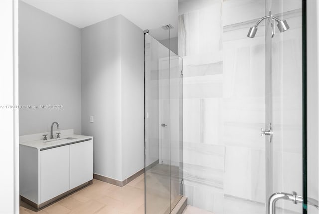 bathroom with tile patterned flooring, vanity, and a shower with shower door