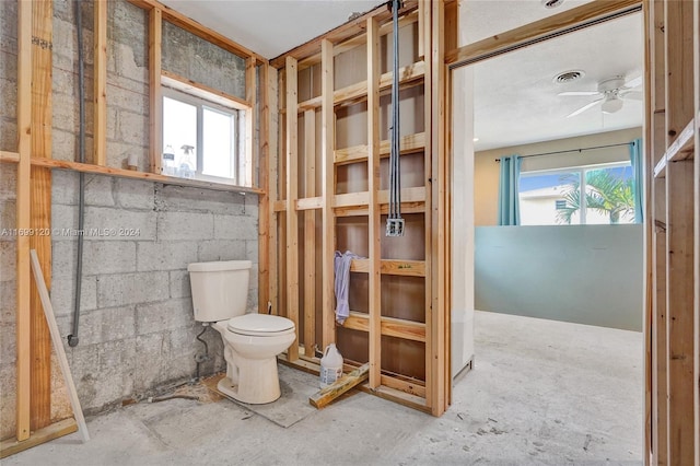 bathroom featuring toilet, plenty of natural light, and ceiling fan