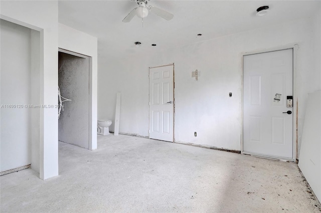 unfurnished bedroom featuring ceiling fan and connected bathroom