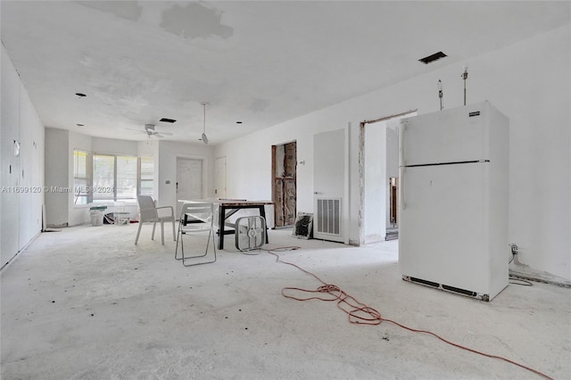 unfurnished living room featuring ceiling fan