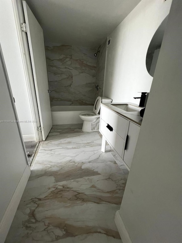 full bathroom featuring vanity, toilet, and tiled shower / bath combo