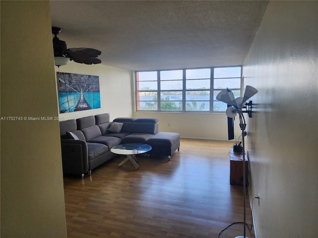 living room with wood-type flooring and a textured ceiling