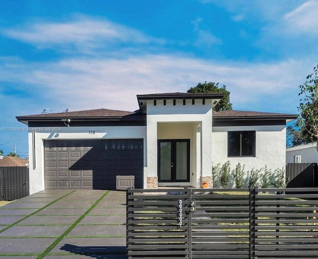 view of front of property featuring french doors and a garage