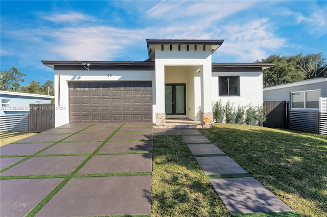 view of front facade with a front yard and a garage