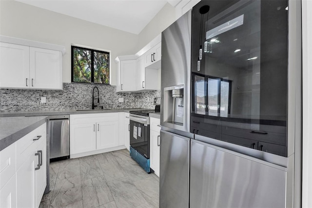 kitchen with white cabinetry, sink, appliances with stainless steel finishes, and tasteful backsplash