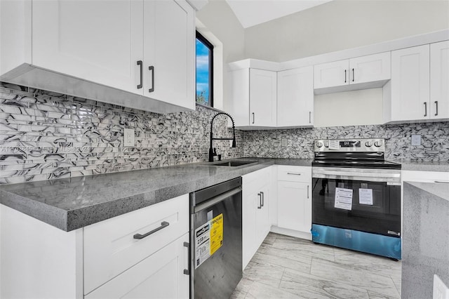 kitchen featuring tasteful backsplash, sink, white cabinets, and appliances with stainless steel finishes