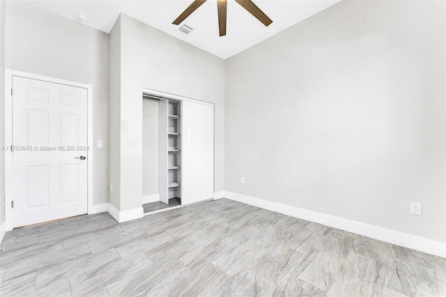 unfurnished bedroom with ceiling fan, a closet, and high vaulted ceiling