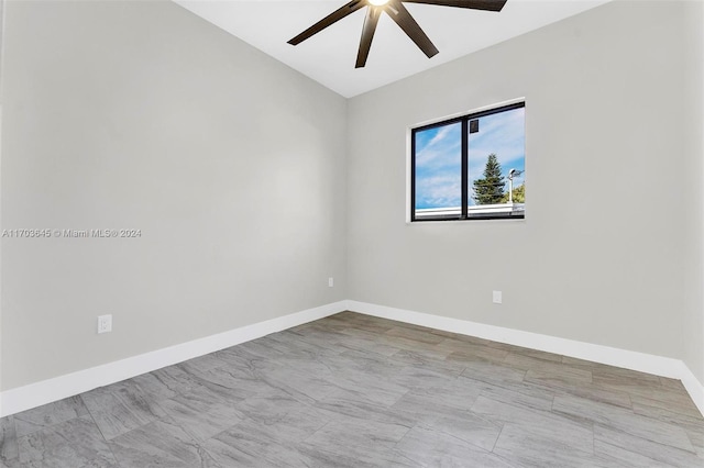 empty room featuring ceiling fan and lofted ceiling