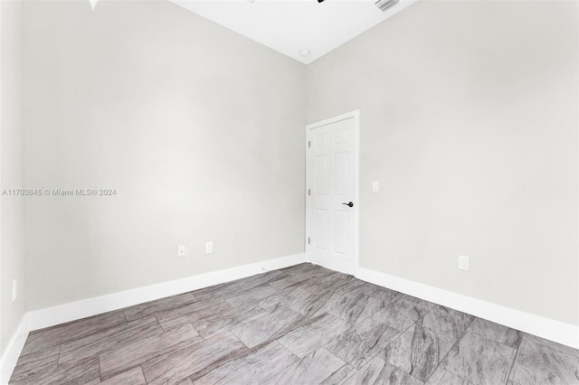 spare room featuring high vaulted ceiling