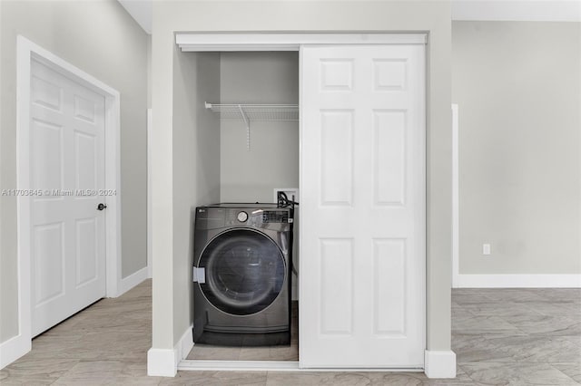 clothes washing area featuring washer / clothes dryer