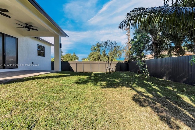 view of yard featuring a patio and ceiling fan