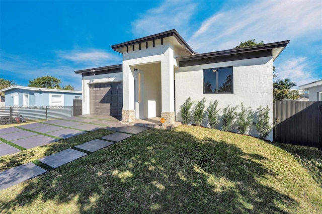 view of front of house featuring a front lawn and a garage