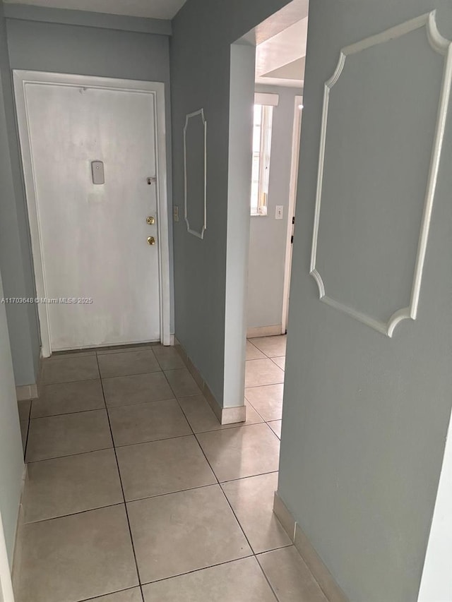 hall with light tile patterned floors