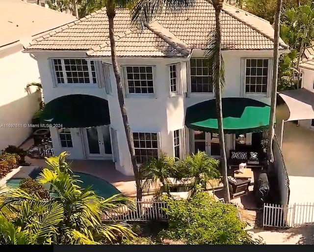 rear view of property with a patio and french doors