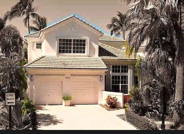 mediterranean / spanish house featuring a garage