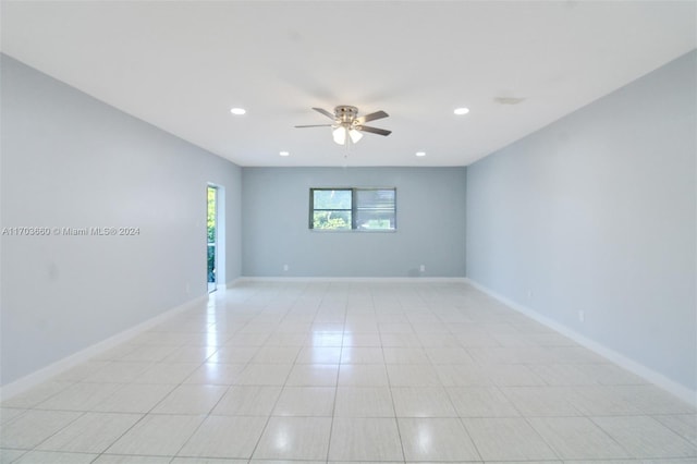 tiled empty room featuring ceiling fan