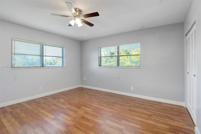 2251 NW 48th Ter Unit 208, Lauderhill, FL 33313 - unfurnished bedroom with multiple windows, a closet, light wood-type flooring, and baseboards