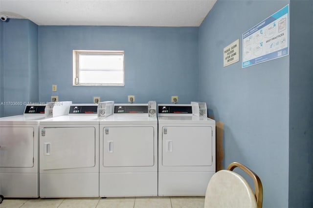 laundry room with light tile patterned floors, a textured ceiling, and independent washer and dryer