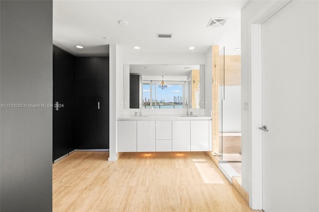 hall featuring a notable chandelier and sink