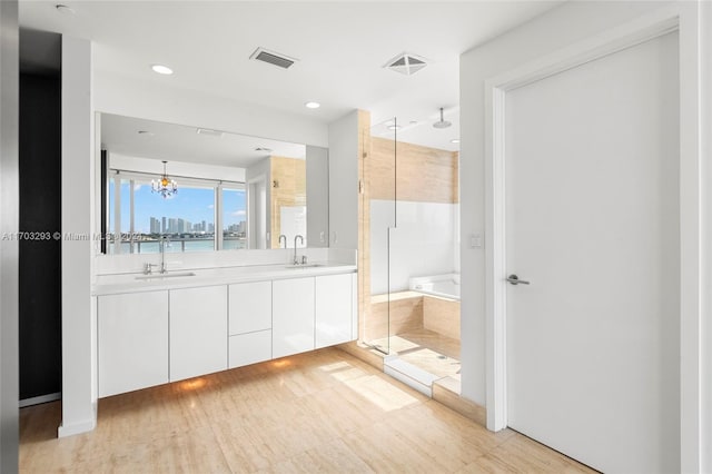 1470 16th St Unit 501, Miami Beach, FL 33139 - bathroom featuring a shower stall, a bath, double vanity, a chandelier, and recessed lighting