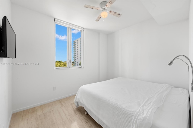 bedroom with ceiling fan and light hardwood / wood-style floors