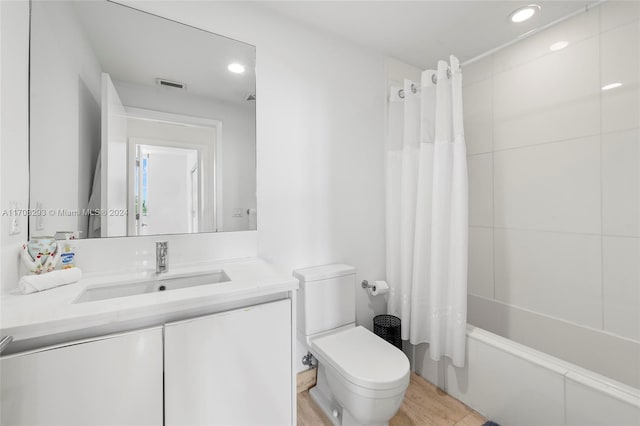 full bathroom featuring vanity, toilet, and shower / tub combo with curtain