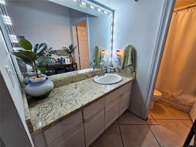 bathroom with tile patterned flooring, a shower with curtain, vanity, and toilet