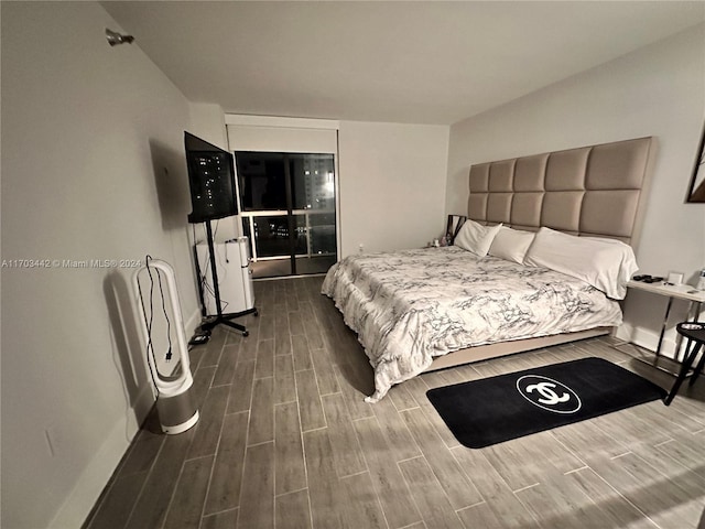 bedroom with dark hardwood / wood-style flooring